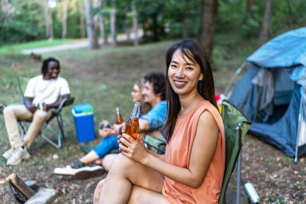 portrait of young smiling beautiful woman enjoying picnic with her friends - cydr zdjęcia i obrazy z banku zdjęć
