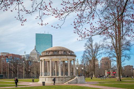 Boston, MA, USA - March 20, 2024: the historic architecture of the Boston Commons in Boston, Massachusetts, USA with some locals passing by.