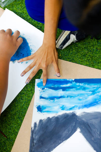 istock Thai student's hand painting with fingers 2117631496