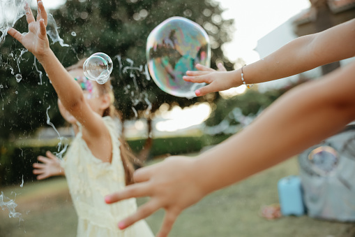 soap bubbles floating on green garden background.