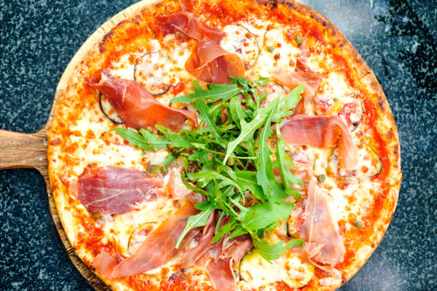istock Top view of bacon pizza with lettuce 2117638417