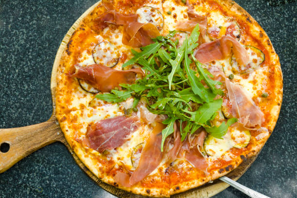 istock View onto bacon pizza with lettuce and fig fruit 2117648043