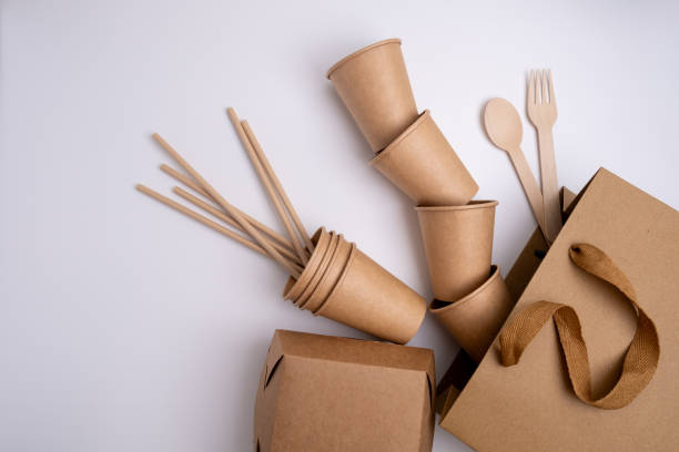 istock Kraft paper tableware: cups, food boxes, isolated on a light background. A set of various disposable tableware. Recycling and zero waste concept. Mock up 2117661391