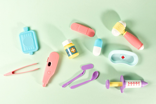 A set of medical toys including a pill bottle, thermometer, syringe
