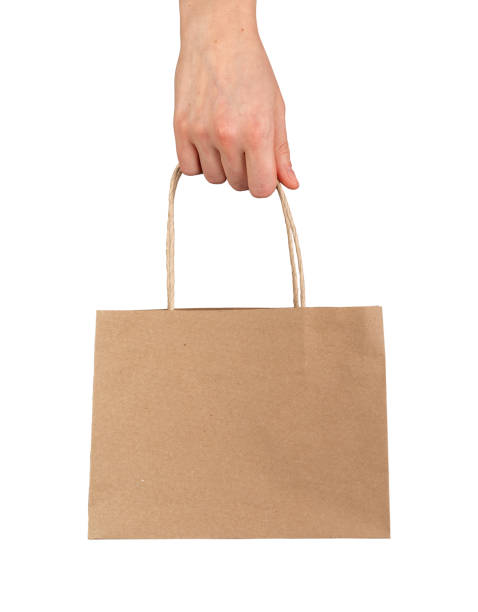 istock Hand holding gift and shopping bag, craft brown package isolated on white 2117700615