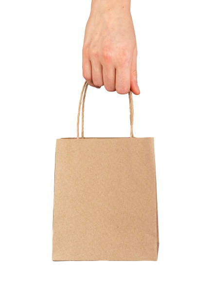 istock Hand holding small gift bag, paper packet, pack with handles, kraft package 2117700616