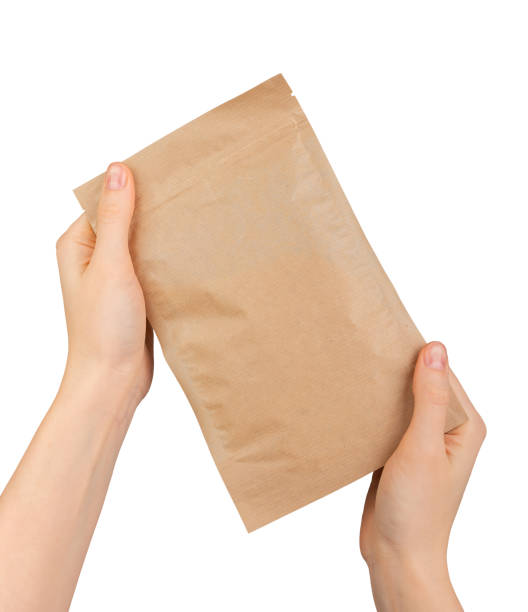 istock Hand holding ziplock paper bag. Zip-lock pouch, kraft eco package 2117700618