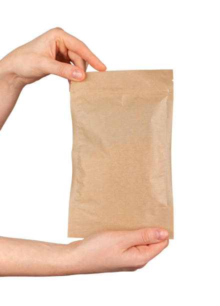 istock Hand holding zip-lock kraft paper bag. Ziplock pouch, craft eco package, soft pack 2117700620