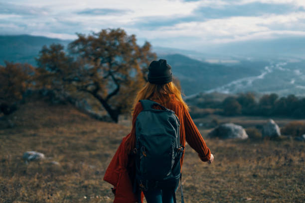 istock woman hiker with backpack on nature landscape dog 2117705372
