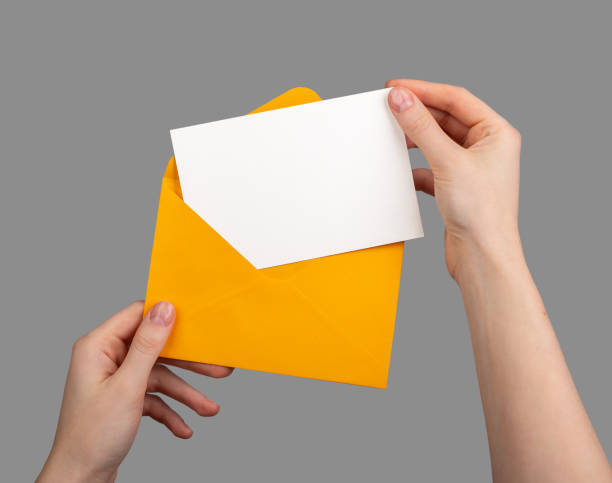 istock Holding an open envelope with a white card inside, blank horizontal postcard mockup 2117706495