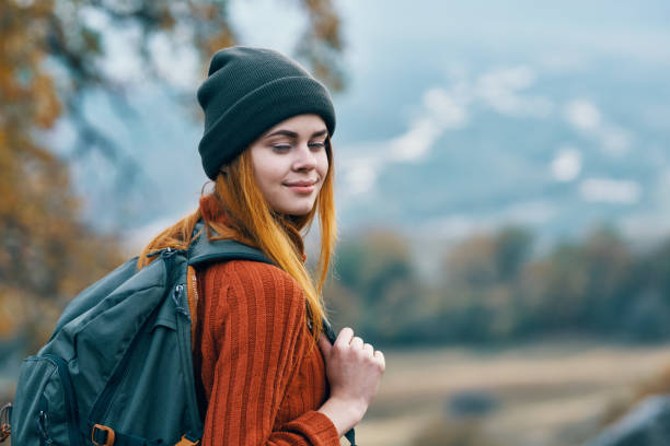 istock woman hiker backpack travel in mountains landscape fun 2117707068