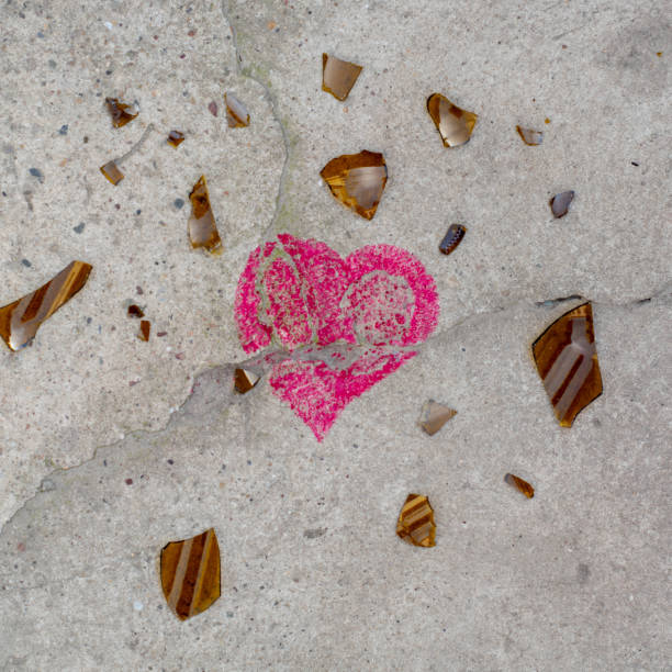 Broken heart on concrete with shattered glass. Creative copy space concept.