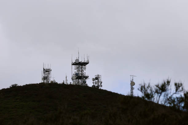 istock Hilltop with multiple communication towers broadcasting a signal 2117742801