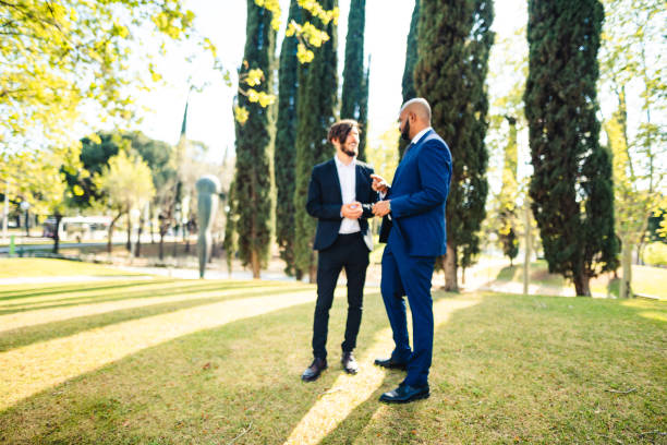 stylish confident man in suit and bowtie, reception at luxury wedding, rich graduation at school or university, business meeting