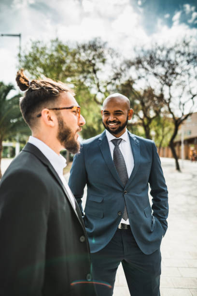 istock business man talking together in the park 2117755953