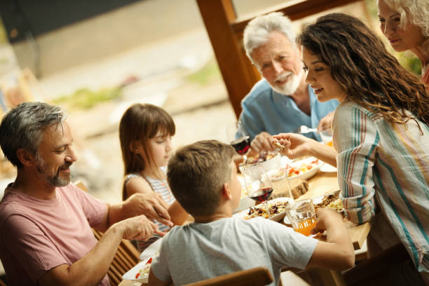 istock Family having dinner at a weekend house. 2117762764