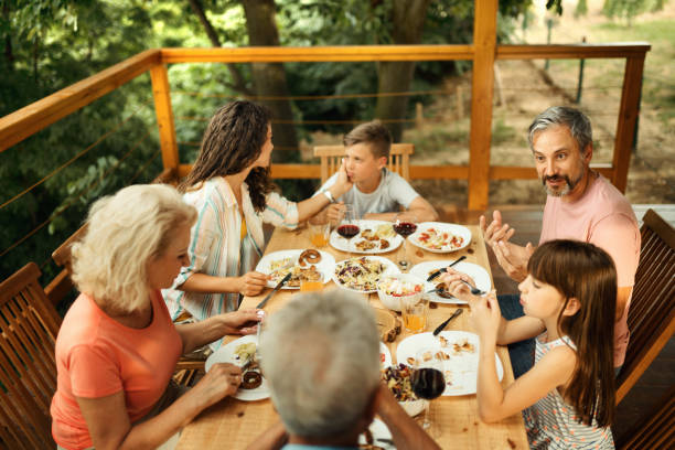 istock Family having dinner at a weekend house. 2117762778