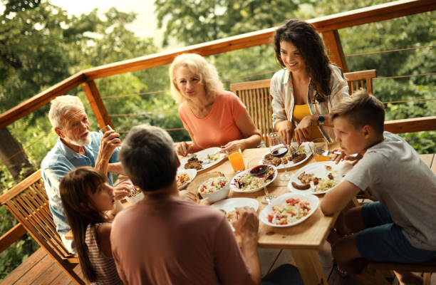 istock Family having dinner at a weekend house. 2117763285
