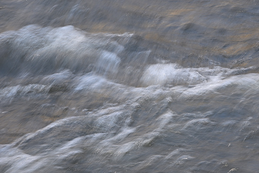 Rough, blowing water on the Shepaug River in Washington, Connecticut, after rain, with copy space on right