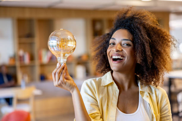 istock Creative businesswoman working at a startup and holding a light bulb 2117819778