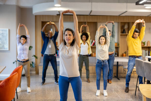 istock Business people taking a break at the office and doing stretching exercises 2117819792