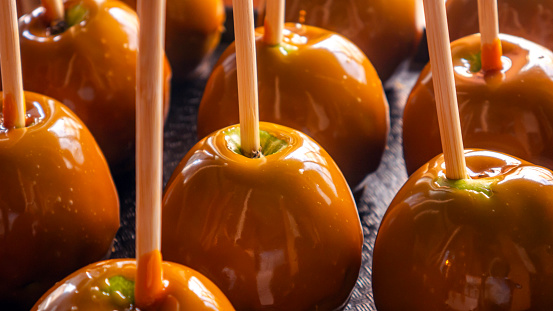 Caramel apples on a tray, sweet treats for autumn, traditional Halloween food