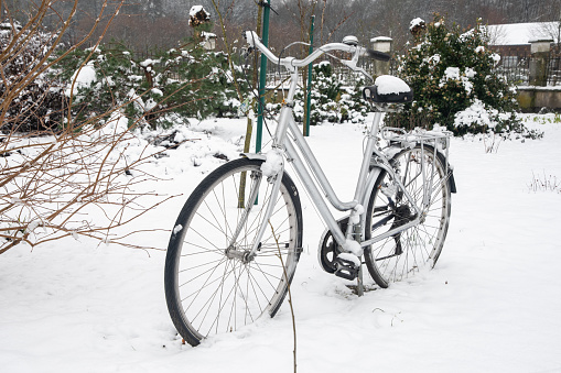 a bicycle forgotten in the yard covered with white fresh snow, Winter scene with lovely bike, Cold and clear day, High quality photo