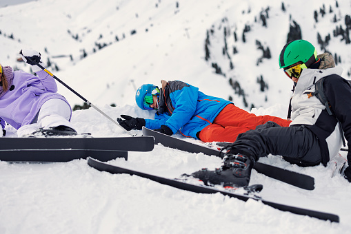 Three teenage skiers lying on the snow after crashing into each other on the ski slope.
Shot with Canon R5