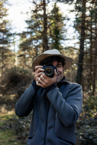 istock vertical portrait Into the Wild: Explorer Capturing Forest Wonders 2117964766