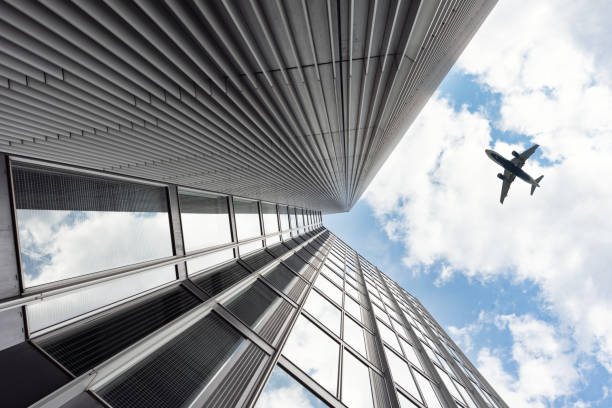 istock The plane flies over a skyscraper. 2117984463