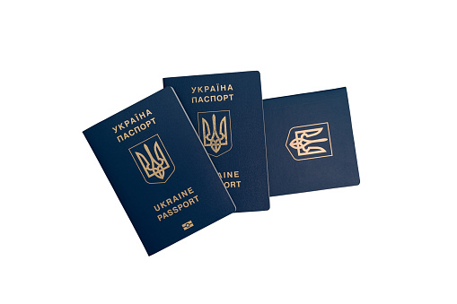 Three passports of Ukrainian citizens or migrants. Isolated on white background.