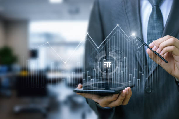 istock An investor analyzes the ETF market traffic graph. 2117999218