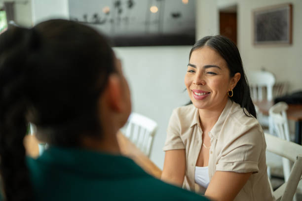 istock Lesbian couple in love talking at restaurant 2118009291