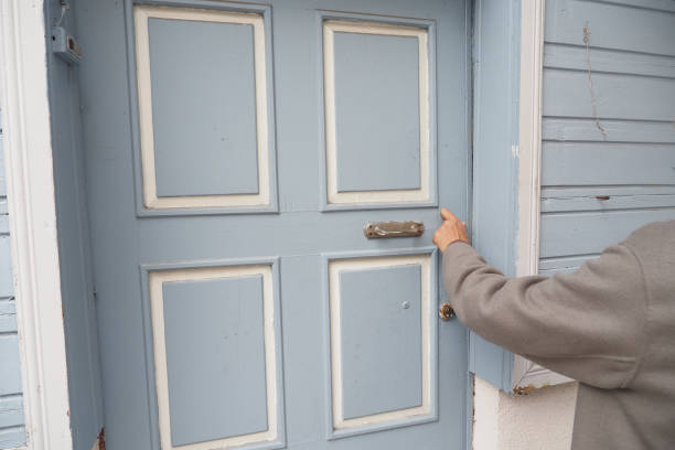 istock women hand knock the door 2118010348