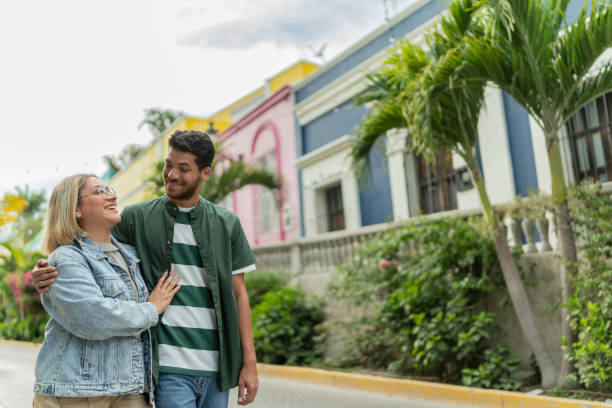 istock Young couple talking and walking through the street 2118011404