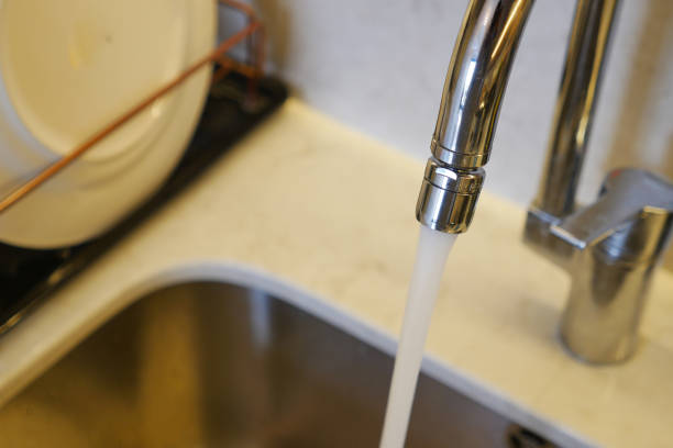 istock water pouring from a faucet tap slow motion 2118011430