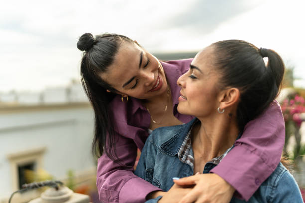 istock Lesbian couple looking each other on a house balcony 2118013048