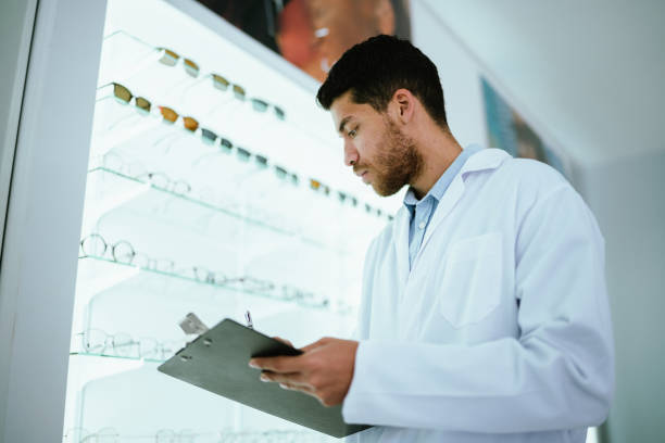 istock Young optician man checking the glasses at the optics 2118020558