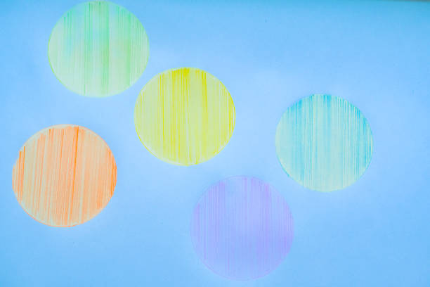 Hand drawn colorful bubbles on blue paper background . Abstract texture drawn with colored pencils. sketch concept with doodles copy space