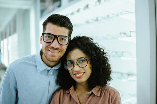 Portrait of young couple at optics