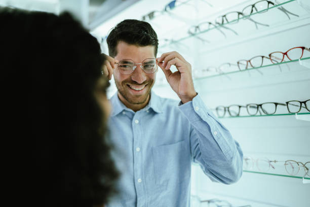 istock Young couple buying a glasses at the optics 2118028595