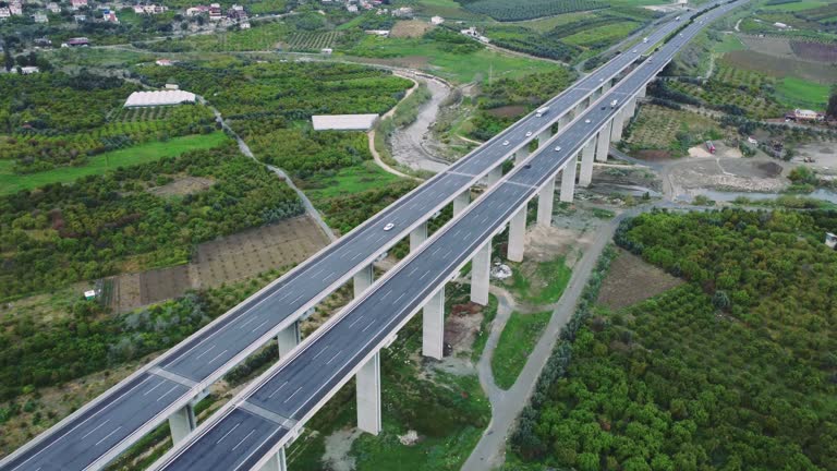 Drone footage of viaduct, valley, agricultural fields. Highlights ecology, viaduct's impact on ecology, agriculture's role in mountain ecology. Explores sustainable development