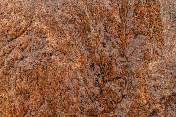 Relief uneven texture of wet rock stone. Abstract background