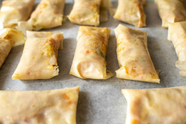 Vegetable spring rolls on baking paper made at home.