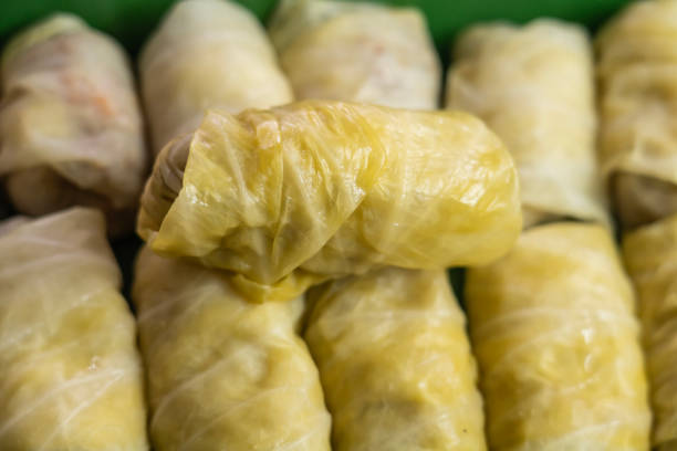 Pile of cabbage rolls with lentils and vegetables in domestic kitchen.