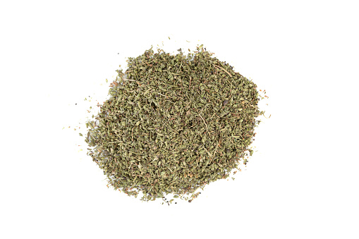 Top view of a bunch of dried thyme leaves on a white background. Food seasoning.