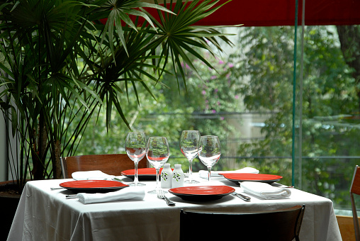 restaurant table with panoramic garden view, view of a modern style luxury restaurant