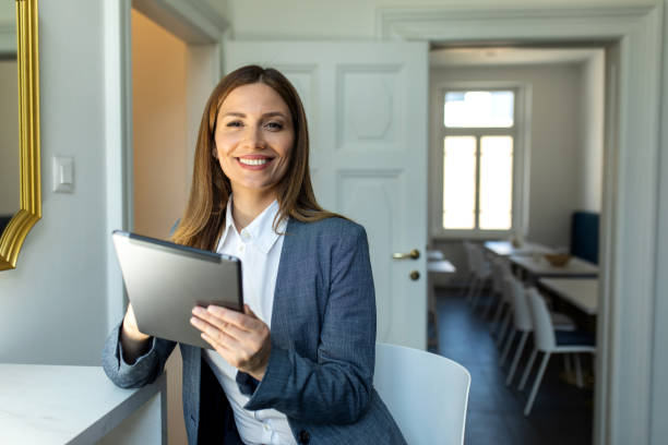 istock Beautiful female surfing the net while holding digital tablet 2118157051