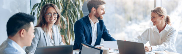 istock Creative business people working on project in modern office with panoramic view 2118166379