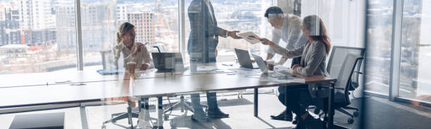 istock Creative business people working on new project in modern office with panoramic view 2118174211